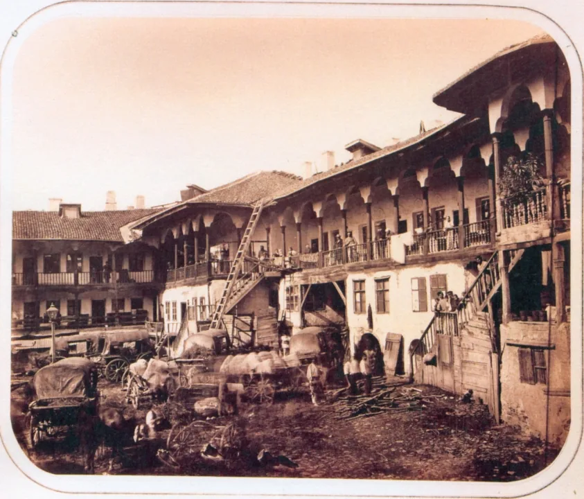 Nineteenth-century view of Hanul lui Manuc, with its wooden gallery and carts in the courtyard
